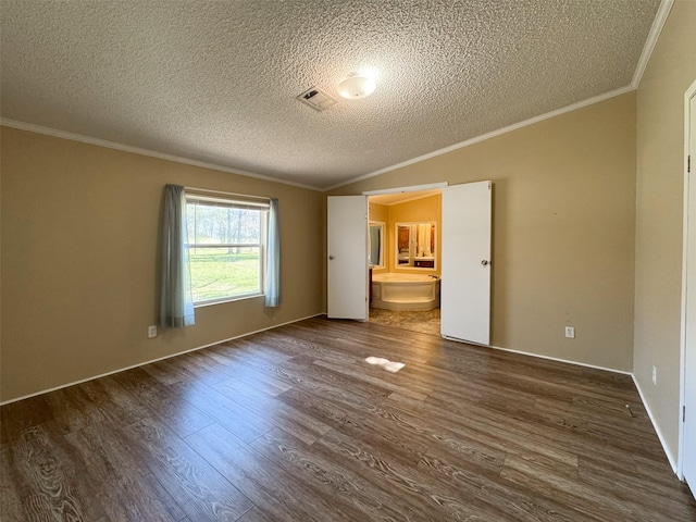 unfurnished bedroom with lofted ceiling, crown molding, ensuite bath, dark hardwood / wood-style floors, and a textured ceiling