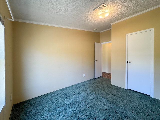 unfurnished bedroom featuring ornamental molding, a textured ceiling, and dark colored carpet