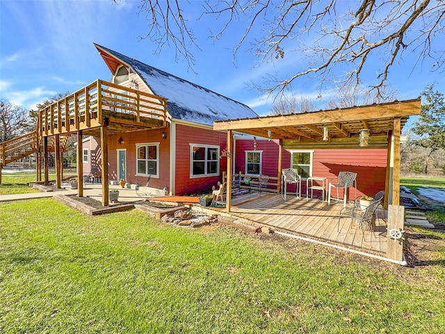 back of property featuring a patio, a deck, and a lawn