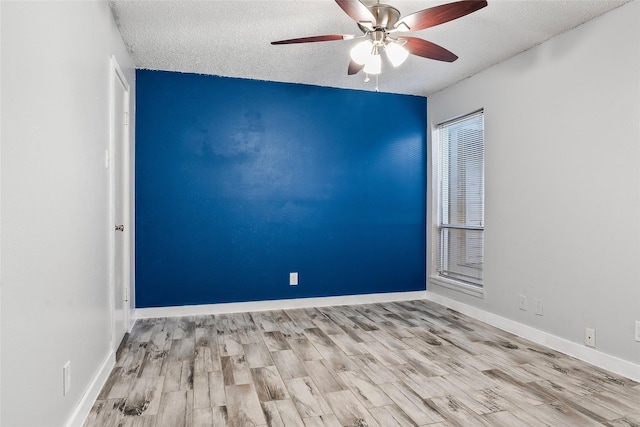 unfurnished room featuring ceiling fan, light hardwood / wood-style flooring, and a textured ceiling