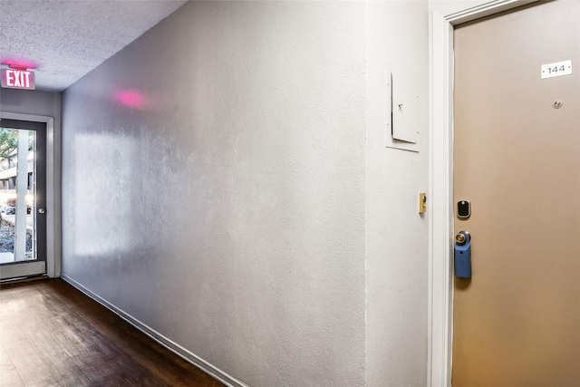 interior space with dark wood-type flooring and a textured ceiling