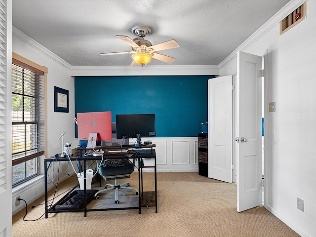 carpeted office with a healthy amount of sunlight, a textured ceiling, ceiling fan, and crown molding