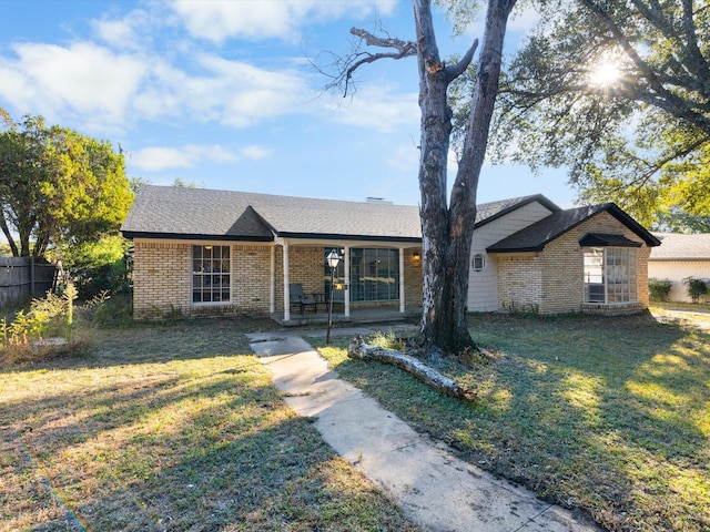 single story home featuring covered porch and a front yard