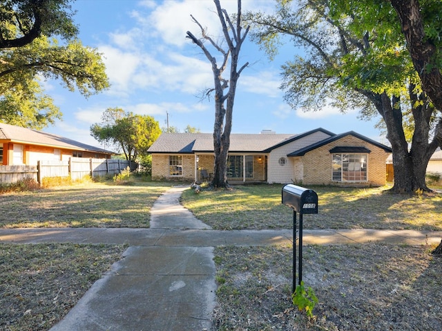 ranch-style home with a front lawn