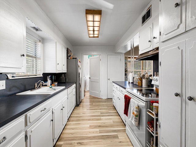 kitchen featuring light hardwood / wood-style floors, sink, white cabinetry, and white stove