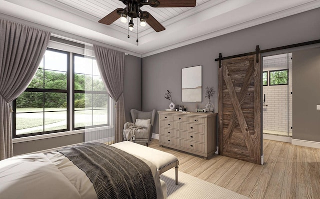 bedroom featuring a raised ceiling, crown molding, light hardwood / wood-style flooring, ceiling fan, and a barn door