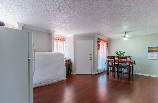 dining space featuring a wealth of natural light, dark hardwood / wood-style flooring, and crown molding