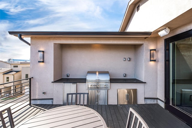 view of patio / terrace with a balcony, area for grilling, and exterior kitchen