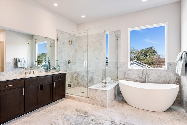 bathroom with vanity, plus walk in shower, and tile walls