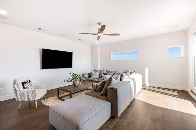 living room featuring ceiling fan and dark wood-type flooring