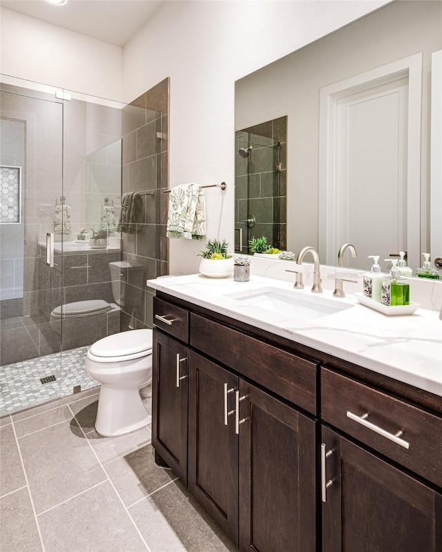 bathroom featuring walk in shower, tile patterned flooring, vanity, and toilet