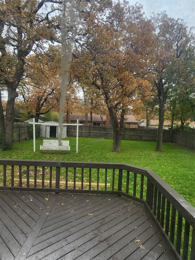 wooden terrace featuring a lawn