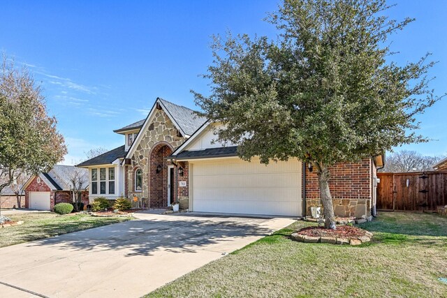 view of front of property with a front yard and a garage