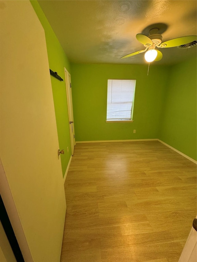 unfurnished room with ceiling fan and light hardwood / wood-style flooring