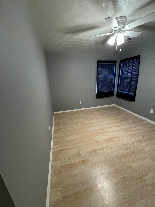 spare room with light hardwood / wood-style floors and ceiling fan