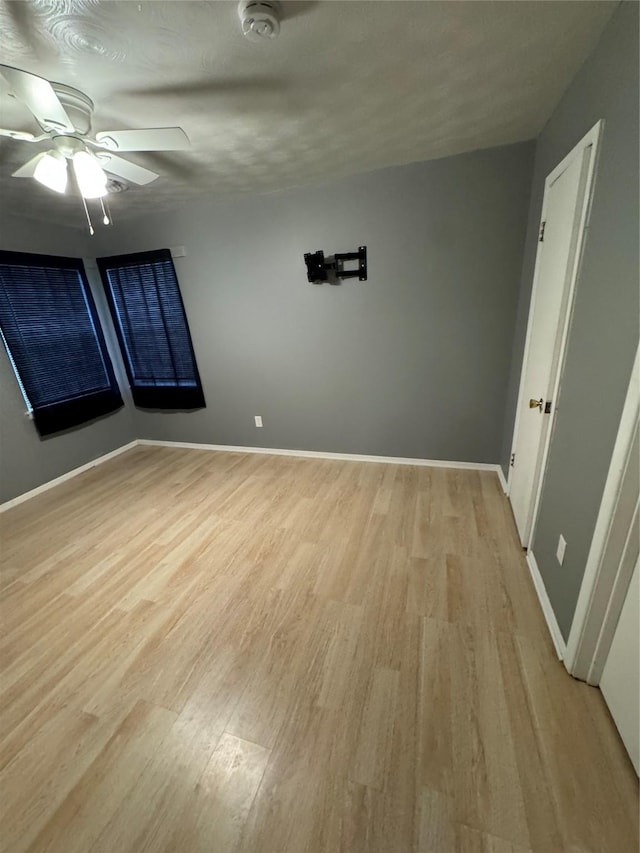 spare room featuring ceiling fan and light hardwood / wood-style floors