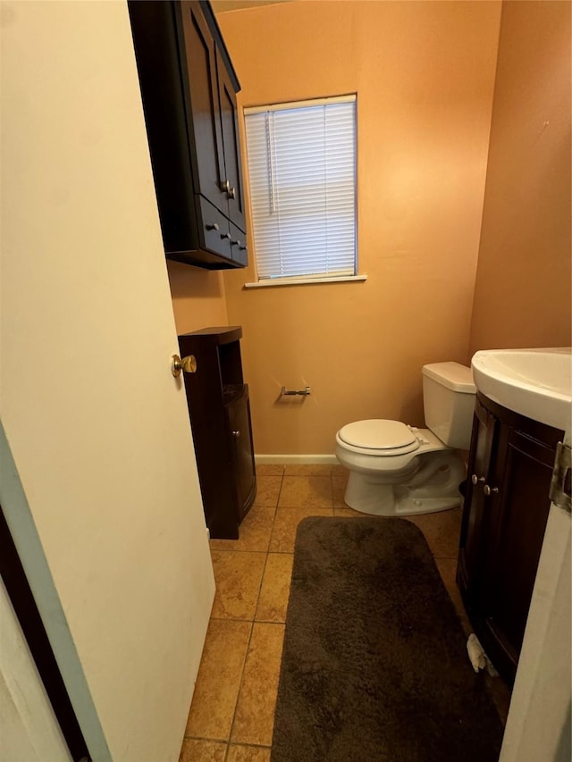 bathroom featuring vanity, toilet, and tile patterned flooring