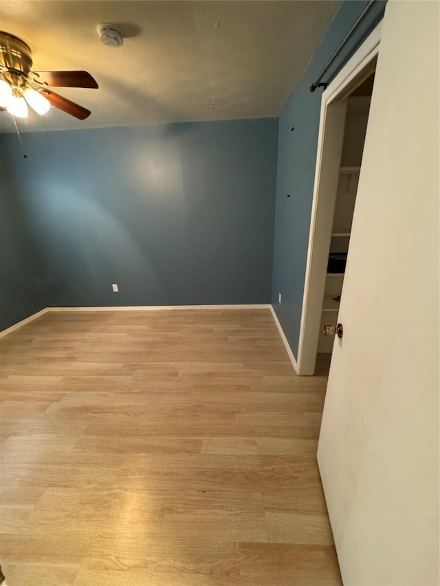 spare room with light hardwood / wood-style flooring and ceiling fan