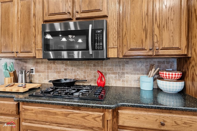 kitchen featuring decorative backsplash and black gas cooktop