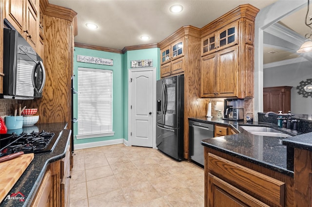 kitchen featuring sink, crown molding, stainless steel dishwasher, refrigerator with ice dispenser, and decorative light fixtures