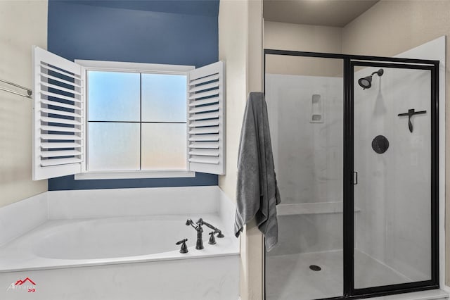 bathroom featuring a healthy amount of sunlight and shower with separate bathtub