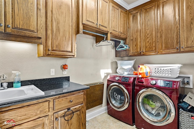 laundry room featuring cabinets, independent washer and dryer, and sink