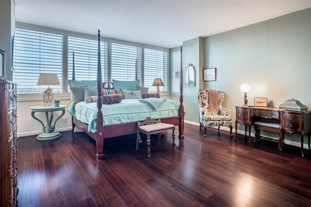 bedroom with dark hardwood / wood-style floors