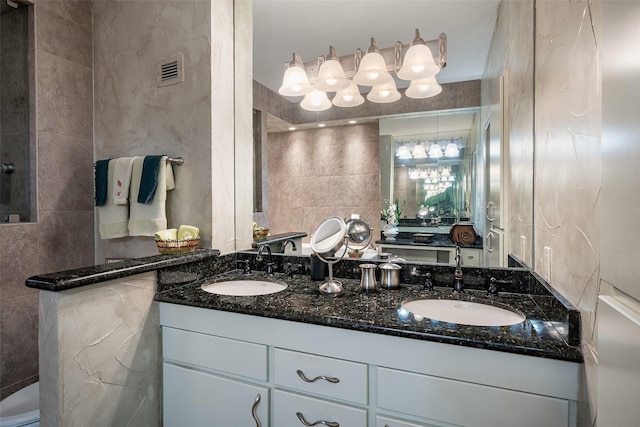 bathroom featuring vanity and tile walls