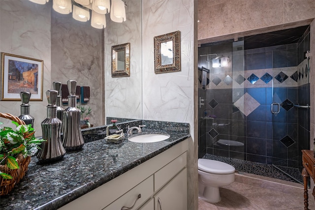 bathroom featuring an enclosed shower, vanity, and toilet