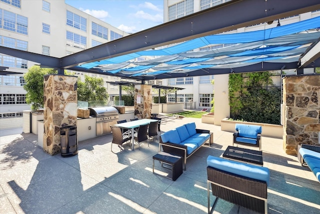 view of patio featuring outdoor lounge area, a pergola, a grill, and exterior kitchen