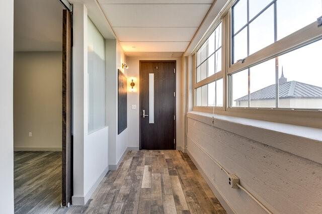 corridor featuring dark hardwood / wood-style flooring