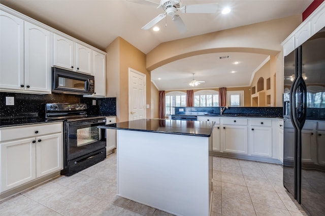 kitchen featuring light tile patterned floors, black appliances, dark countertops, and white cabinetry