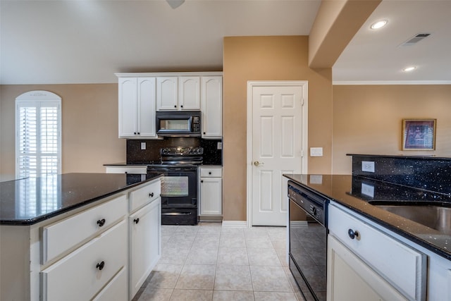 kitchen featuring light tile patterned flooring, white cabinets, black appliances, tasteful backsplash, and dark stone countertops