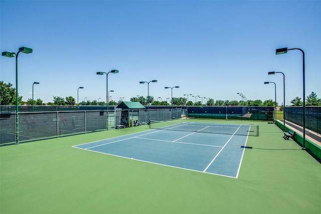 view of sport court featuring fence