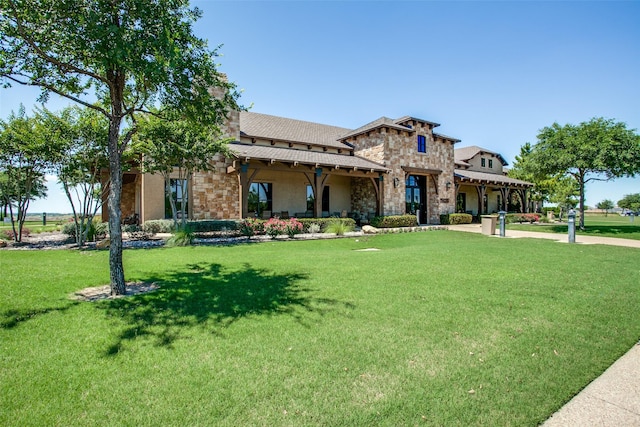 view of front of house with a front yard and stone siding