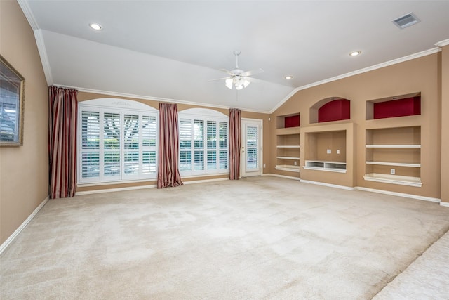 unfurnished room with light carpet, built in shelves, ornamental molding, and visible vents