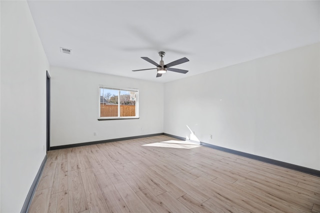 empty room with ceiling fan and light wood-type flooring