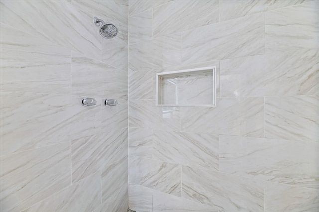 bathroom with tiled shower