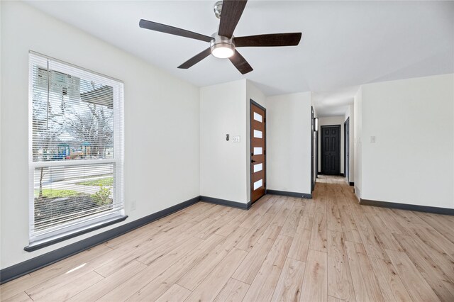 spare room featuring ceiling fan and light wood-type flooring