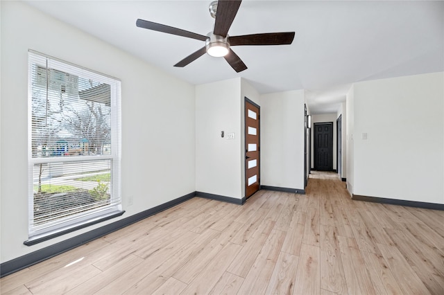 unfurnished room with ceiling fan and light hardwood / wood-style flooring