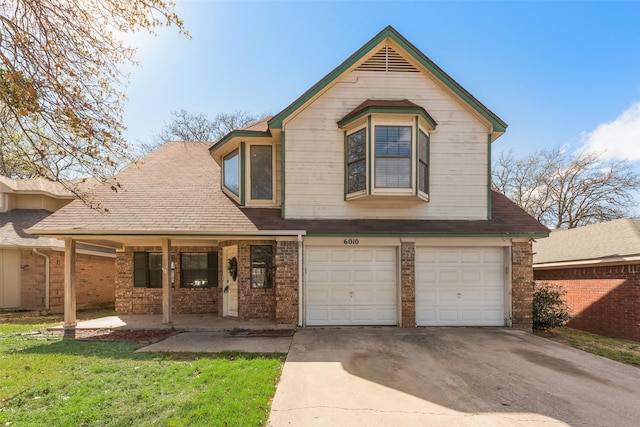 view of front of home with a front yard, an attached garage, brick siding, and concrete driveway
