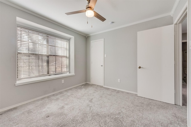 unfurnished bedroom with a ceiling fan, carpet floors, ornamental molding, and baseboards