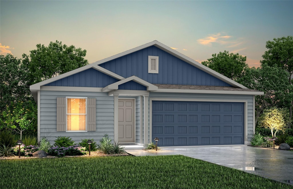 view of front of property with a yard and a garage