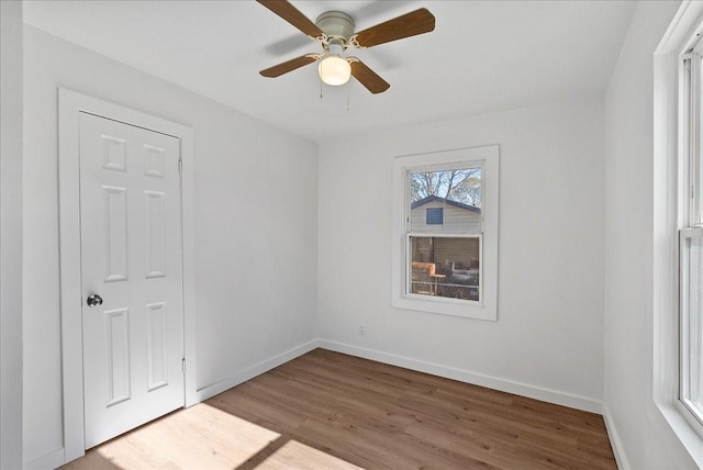 unfurnished room with ceiling fan and wood-type flooring