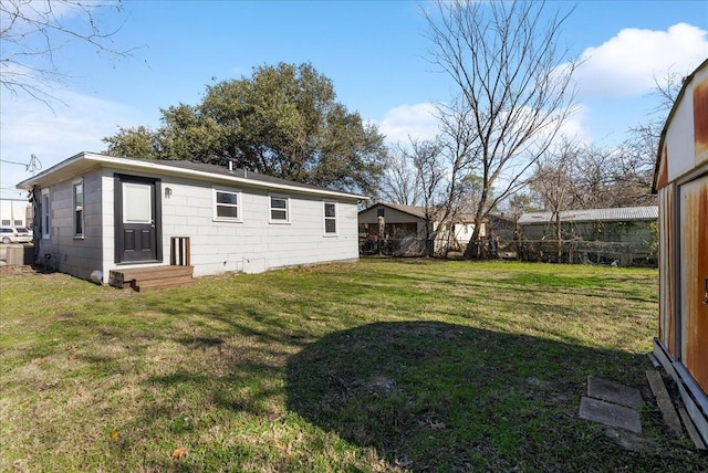 rear view of property featuring a yard