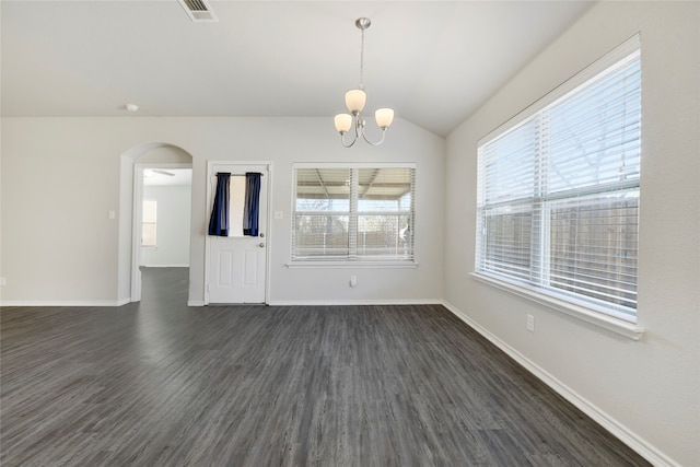 interior space featuring dark hardwood / wood-style floors, vaulted ceiling, and a notable chandelier