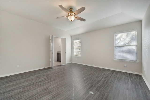 unfurnished room with vaulted ceiling, ceiling fan, and dark wood-type flooring