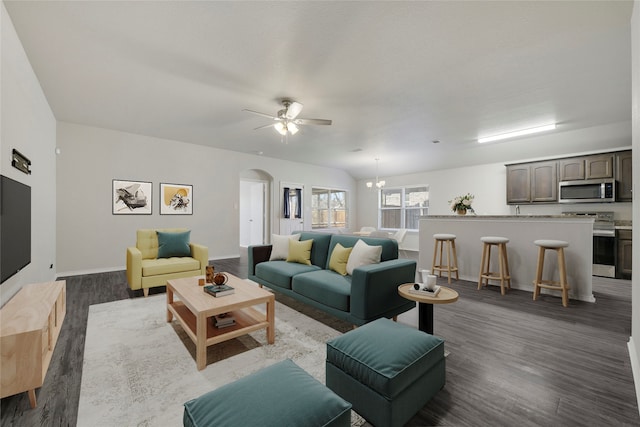 living room with hardwood / wood-style flooring and ceiling fan with notable chandelier