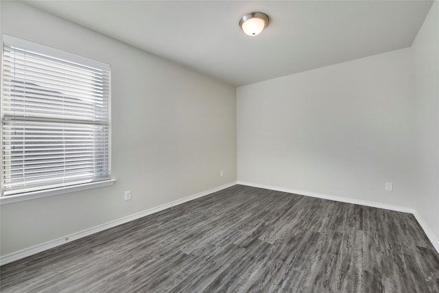 spare room featuring dark hardwood / wood-style floors