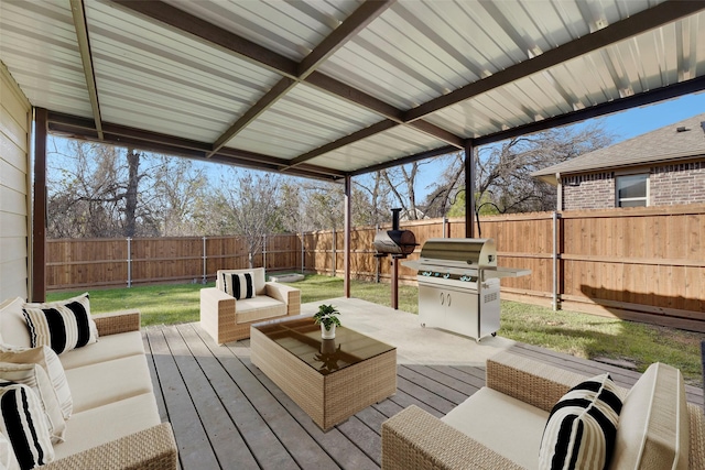 wooden deck with outdoor lounge area, a grill, and a lawn